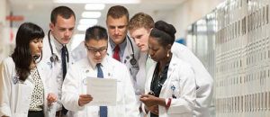NURSE PRACTITIONER STUDENTS LOOK OVER A PATIENTS CHART