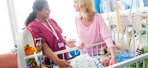 A NEONATAL NURSE SPEAKS WITH A NEW MOTHER