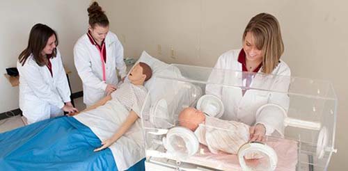Nursing Students Practice On An Infant Manikin